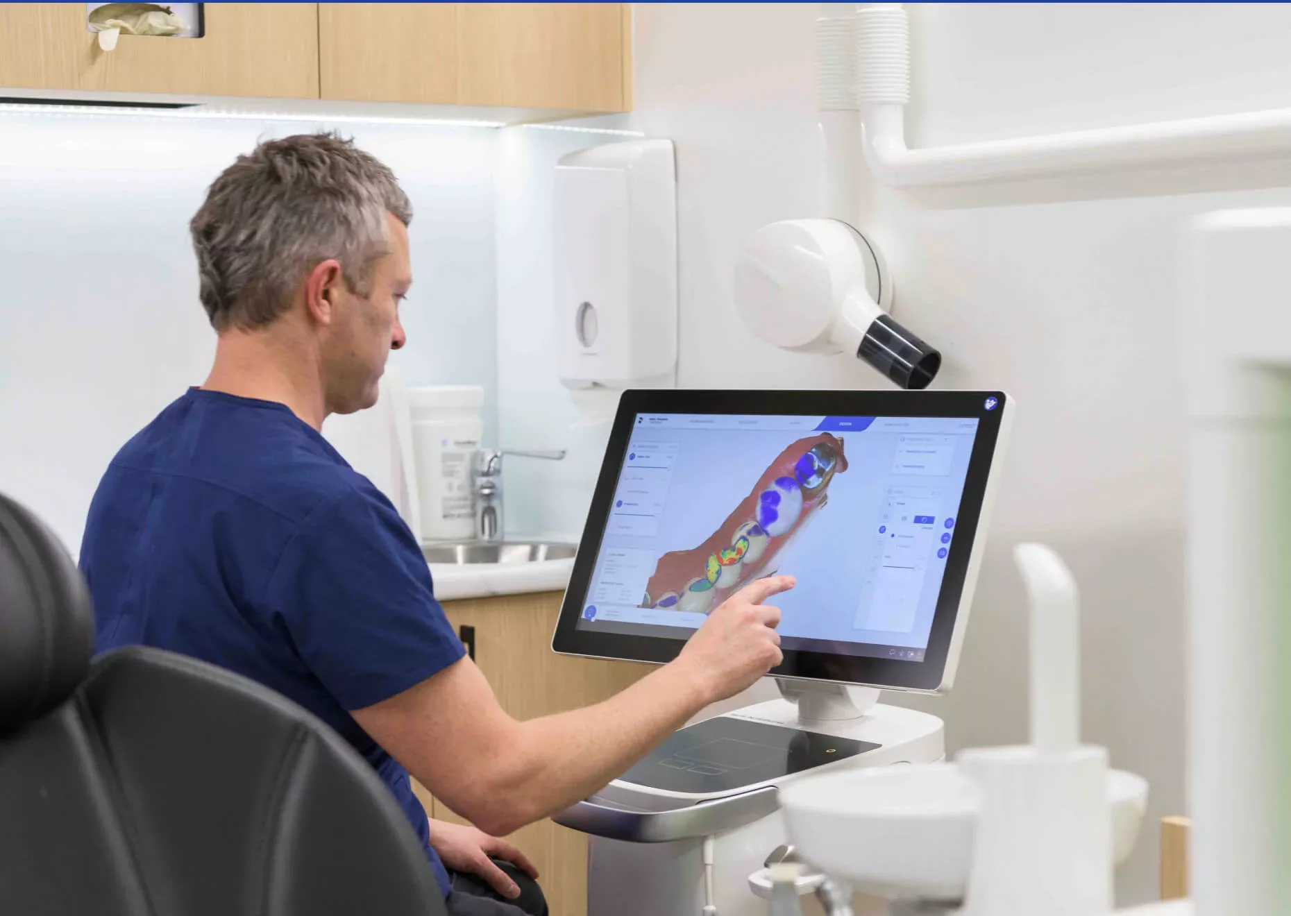 Gentle Dental dentist examining dental imagery